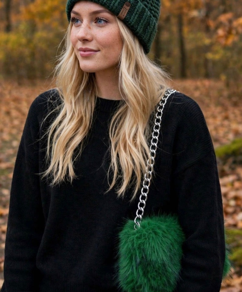 Model wearing Evergreen handmade green beanie with coordinating faux-fur handbag
