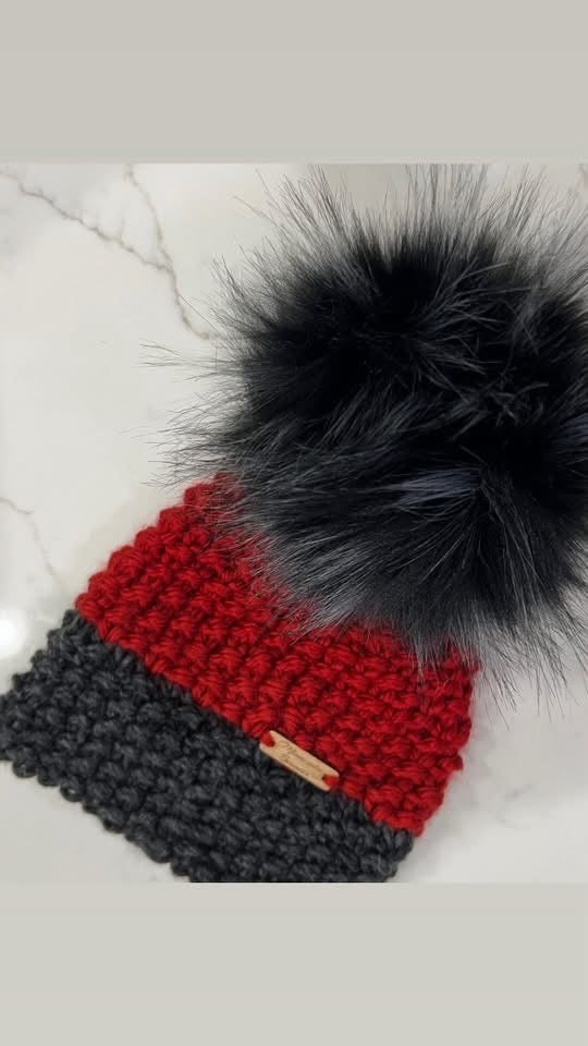 Northwoods Ember handmade red and charcoal beanie with black faux fur pom